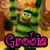 Green striped character with orange hair bow, brown tree background, pink text overlays reading 'Grobi', 'is', 'my', and 'husband' across four