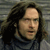 Pixelated close-up of a person with long dark hair wearing a dark blue top against a gray striped background.
