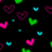 Animated pattern of colorful heart shapes in pink, green, and cyan floating against a black background with scattered small dots.