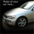 Pixelated silver sedan with visible front wheel and headlight, positioned on dark background with light reflecting off its hood.