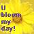Static pixelated icon featuring a yellow sunburst background with purple text reading "U bloom my day!" and a brown circular object resembling a flower or fruit.