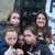 Group of five people in a pixelated image with varying expressions and poses, some smiling, others neutral.