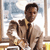 Static 50x50 pixel icon depicting a man in formal attire holding a child, set against an interior background with window and furniture elements.