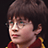 Pixelated image of a person with brown hair and glasses wearing a red garment with yellow trim, next to light green text on dark background.