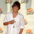 Pixelated image of a person in white clothing with text elements on cyan background.