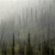 Pixelated grayscale image with vertical dark shapes against a gradient background transitioning from light gray at top to darker gray at bottom.