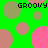Green background with scattered pink, brown, and green circles; four instances of 'GROOVY' text in black pixelated font; some circles partially overlap others.