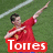 A person in a red shirt and blue shorts on a green field with white lines, making a gesture with arms extended.