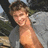 A person with light brown hair and a gray jacket over bare shoulders appears in three showing slight head movement