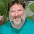 A person in a teal shirt lies on grass with arms behind head, next to bold black text reading DON'T FEED PHIL.