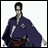 Pixelated image of a character in a purple robe with red sash, standing against white background, next to black with white text