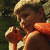 A child in a life jacket with the word 'canada' overlaid on one frame, set against green foliage background.