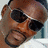 Two side-by-side pixelated faces: left face wears dark sunglasses, right face is pale with visible ear and neck.