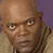Static pixelated image of a bald man's face with neutral expression against purple and beige background.