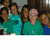 Group of people in green and blue shirts, a horse with rider text, and four individuals including one wearing 'I ❤️ DC' shirt.