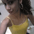 A pixelated image of a person with dark hair wearing a yellow sleeveless top, partially cropped on the left side.
