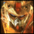 A pixelated close-up of a stylized animal face with glowing eyes and sharp teeth, rendered in warm orange and brown tones.
