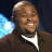 Static pixelated image of a person with light brown skin wearing a dark jacket and white shirt, featuring a bright blue glowing effect on the left side against a dark background.
