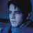 Pixelated static icon of a person's face with dark hair and blue-toned background, rendered in low-resolution 256x256 pixels.