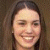 Static 50x50 pixel icon showing a close-up of a person's face with long dark hair against a brown background, rendered in low-resolution pixel art style.