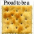 A square cracker with browned spots and small holes, under the text "Proud to be a" in dark gray letters.