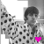A black-and-white animated contact sheet showing two frames of a person in a polka-dot shirt with a pink heart symbol appearing and disappearing between frames.