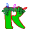 Green letter R with red outline, green foliage on top, blue and pink gem-like shapes above foliage, small red leaf-shaped detail near right side of R.