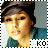 A pixelated portrait of a person wearing a dark cap and blue garment, with text elements below the image.