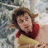A pixelated buddy icon featuring a person with brown hair and red clothing on the left side, next to white text reading "Tumnus is a hottie!" on a gray background.