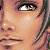 Pixelated close-up of a person's face showing eye, nose, mouth, and hair with warm skin tones and dark hair strands.