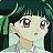 Pixelated character with large eyes and pink cheeks, wearing a light blue outfit with a green headband, set against a dark green background.