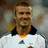 A pixelated image shows a person in a white sports jersey with black collar and yellow trim, standing next to a classic black-and-white soccer ball on green grass.