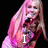 A pixelated image of a person with long pink hair holding a microphone, displaying text changes