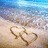 Beach scene with two hearts drawn in sand, waves receding on shore under blue sky.