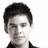 Two side-by-side grayscale portraits of a person with short dark hair wearing a dark collared shirt against a white background.
