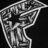 Pixelated grayscale icon of a stylized figure with outstretched arms against black background, rendered in low-resolution blocky style.