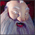 Santa Claus face with closed eyes and open mouth, next to text about The Nightmare Before Christmas Blu-ray and DVD release.