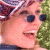 A pixelated image shows a person with light skin wearing dark sunglasses and a patterned head covering, next to green text reading 'Original Icons .com' on a solid background.