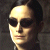 Pixelated close-up of a person's face with dark hair, wearing dark sunglasses against a dark background.