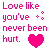 Pixelated text and symbols in pink, green, blue, black, white, and gray on a white background with a solid gray rectangle.