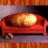 A pixelated red couch with a glowing yellow cushion, set against a gradient background of purple and orange hues.