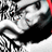 Pixelated grayscale image of a stylized face with dark hair, large eyes, and a white mouth area against a black background.