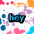 Pixelated icon with 'hey' text in cyan on black, surrounded by scattered colorful pixel clusters including pink, blue, purple, orange, and white.