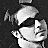 identical grayscale cartoon faces with dark sunglasses and a small yellow heart symbol below each face, arranged in on a black background