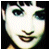 A pixelated close-up of a person's face with dark hair and bangs, showing subtle mouth movement