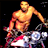 Static pixelated image of a shirtless man in athletic pose holding a microphone against dark background with colorful lower-body elements.