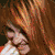 A pixelated image of a person with long red hair in multiple poses, including a side profile and a front-facing view with a smile.