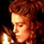 Pixelated static image of a person with curly red hair holding a glowing object against dark background.