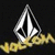 A diamond-shaped logo with black and white sections sits above yellow text on a dark background, with one instance showing a gray rectangle overlay.