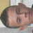 Pixelated close-up of a person's face with brown hair, visible ear, and light skin tone against a blurred background.